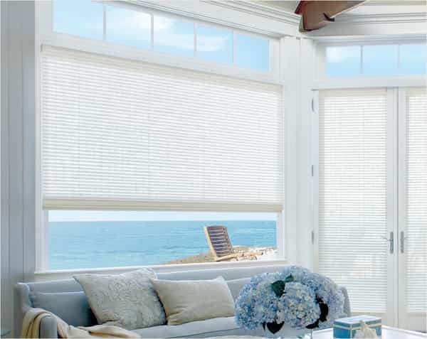 Woven Blind Living Room — Bring coastal style to your living room with woven wood natural blinds - a sandy color palette with touches of blue